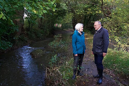 Claire Young and Ed Davey beside the River Frome in Frampton Cotterell