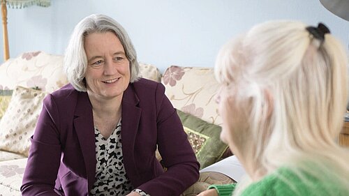 Claire discussing local healthcare with a resident