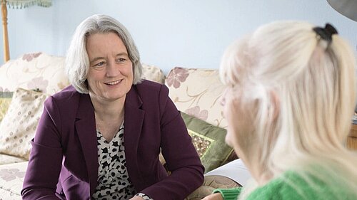 Claire Young speaking to a resident about their concerns